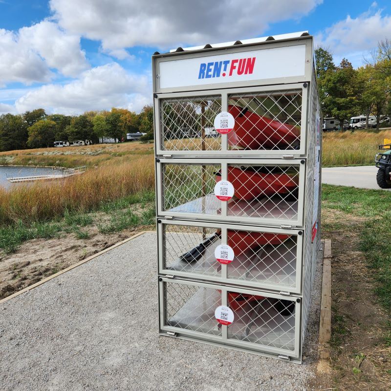 Self-service rental kiosk cage beside lake