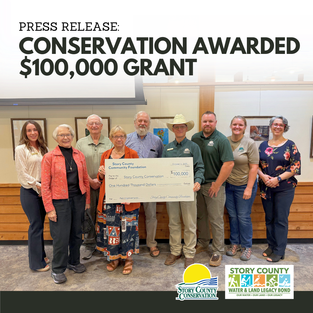 Story County Conservation employees pose with giant check written for $100,000