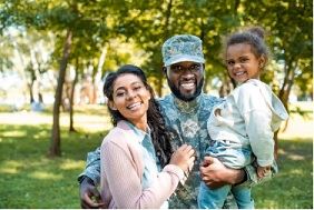 Image of a military service member and his family