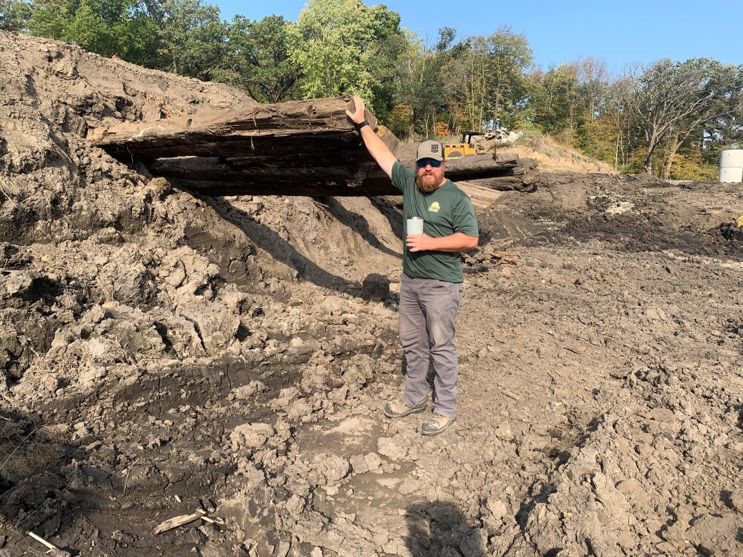 Large timbers stick out from lake side to provide future fish habitat. Over six feet high