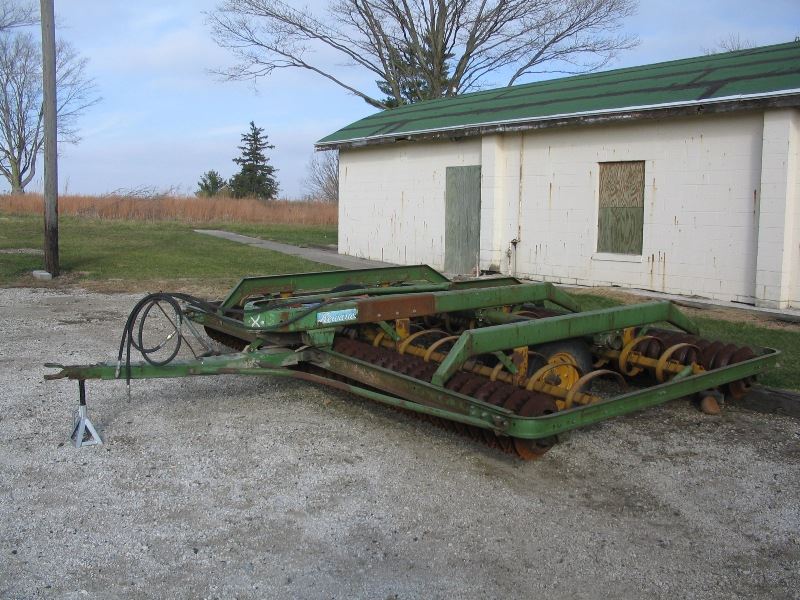 Cultimulcher equipment sitting in front of buildling